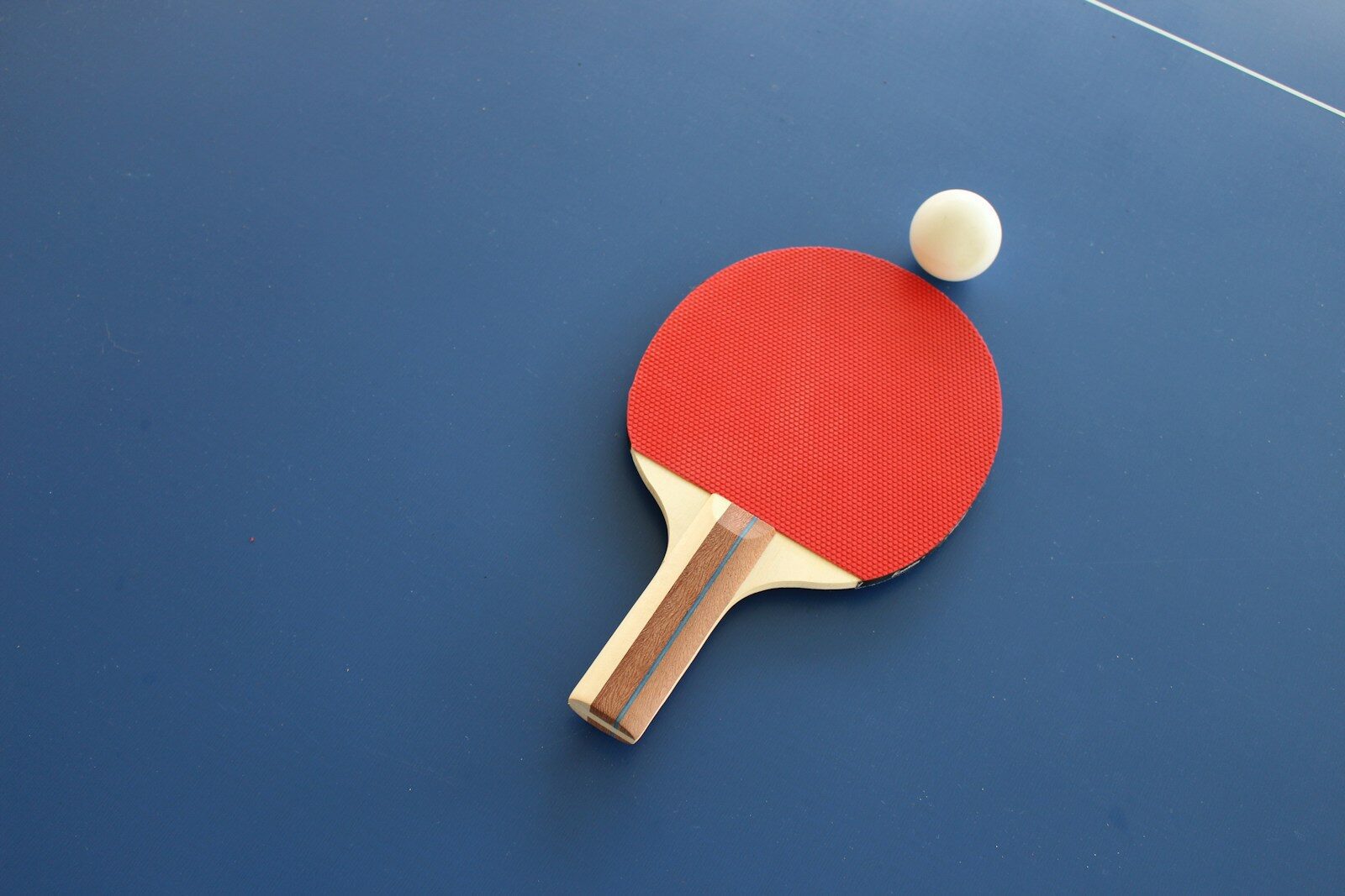 Photo by Lisa Keffer red and brown wooden table tennis racket
